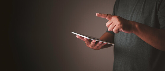 Businessman using digital tablet pointing up and showing with thumb up for touch for put virtual screen or text