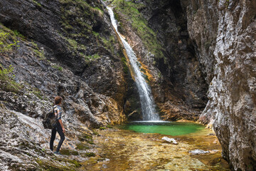Woman Hiker Discover one of Beautiful Zapotoski Waterfalls in Zadnja Trenta Valley Slovenia