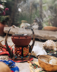 Obraz na płótnie Canvas Traditional colorful Maya incense burner with smoke during sacred ritual in the tropical forest of Tulum