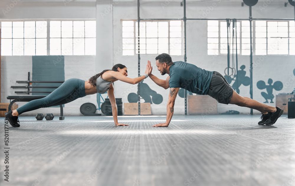 Canvas Prints Fitness partners exercising together and doing pushups high five at the gym. Fit and active man and woman training in a health facility as part of their workout routine. A couple doing an exercise