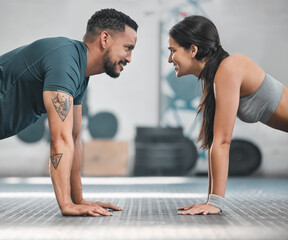 Fototapeta na wymiar Fitness, health and active couple training together in a gym doing exercise workout for healthy lifestyle. Young and focused athletic friends doing pushups indoor. Good teamwork for wellness goals