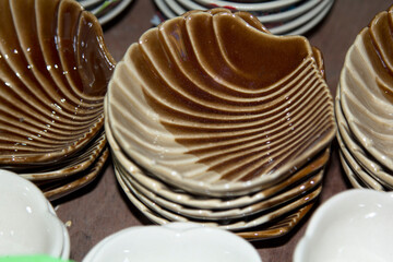 Pottery and ceramics that are modernly designed, such as dishes, mugs, small pots and many shapes, spheres, squares, as food containers. Coffee and others are sold at various shops and festivals.