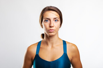 Fototapeta na wymiar Portrait of a sports girl. Female runner against gray background..