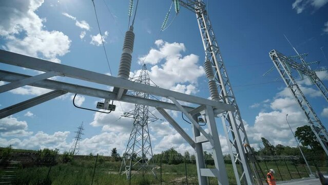 Many high voltage electrical insulators in power substation against blue sky background