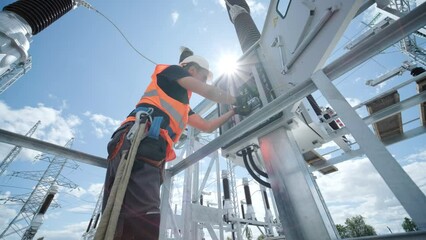 Electrical engineers inspect the electrical systems at the equipment control cabinet
