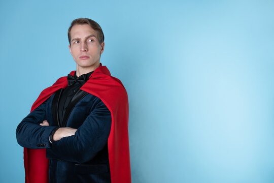 superhero stands in a heroic pose, a man in a business suit and a red cape. charismatic and successful business hero.