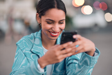Trendy, happy and modern woman texting on a phone, browsing social media or surfing the internet. Single female looking confident and relaxed, smiling while reading a message on an online dating app - obrazy, fototapety, plakaty