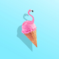 Pink flamingo in ice cream waffle cone. Minimal abstract caribbean concept of summer and vacation in the tropics by the sea, a trendy collage on a blue background.Creative art minimal aesthetic
