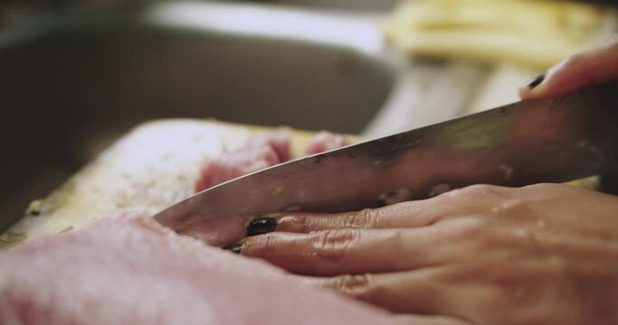 close up of cutting pieces of tollo fish to prepare ceviche.