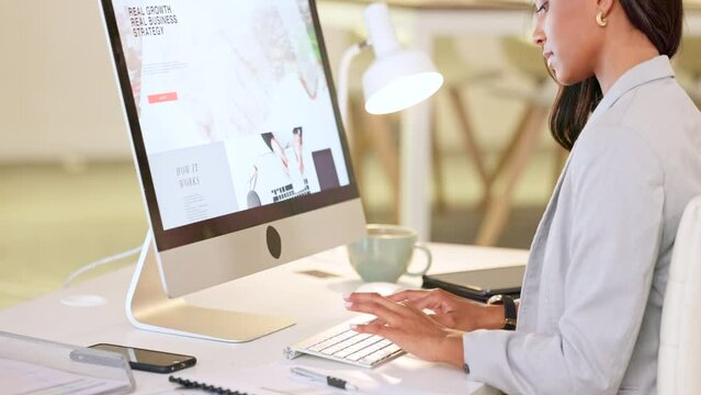 Web or graphic designer typing on a computer and designing a website in her office. Female doing digital creative planning and editing an app layout for better user experience