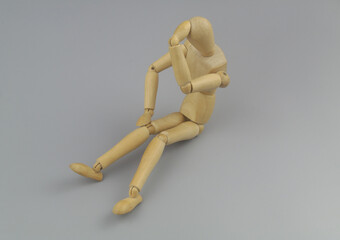 Wooden figurine thinking on gray background, copy space for text