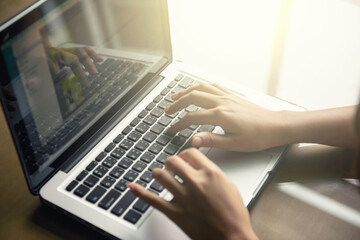 Fototapeta na wymiar Cropped image of a woman working on laptop