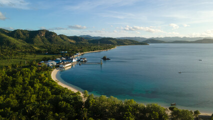 Fototapeta na wymiar drone view of tropical island, hills and forest by the beach in the evening