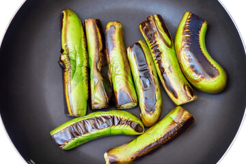 Roasting  green eggplant on pan