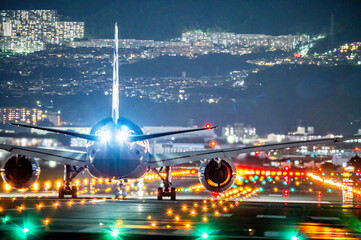 Passenger plane waiting to take off on runway at night