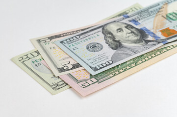 5, 20, 50, 100 dollars banknotes at different angles. Close up of dollars on white background.