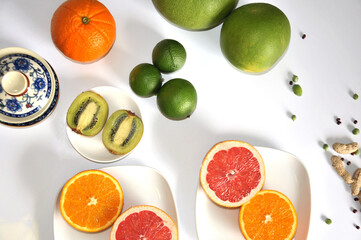 Fresh oranges and kiwi sliced on a plait