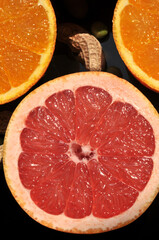 Fresh oranges and kiwi sliced on a plait