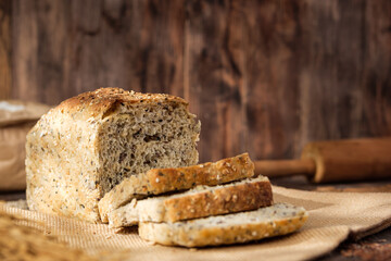 whole wheat baking bread with grains for healthy eating on wood table in kitchen