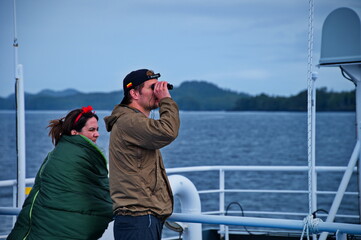 Mature couple standing on the deck of the ferry