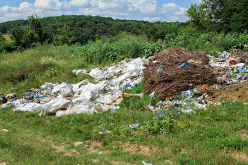 View of the landfill. Landfill A pile of plastic garbage, food waste and other garbage. Pollution...