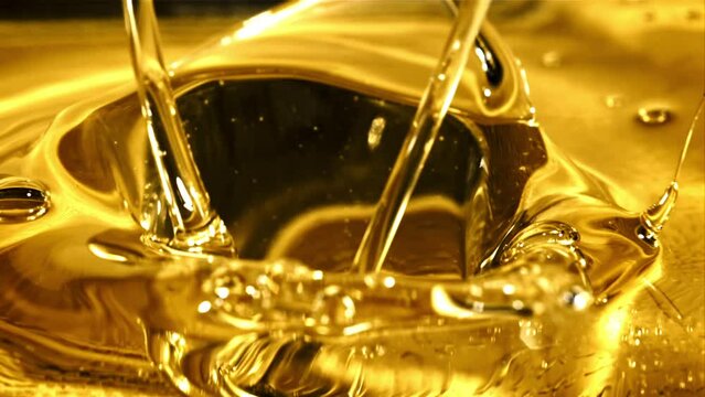 Olive oil pours with splashes. The texture of olive oil. Filmed on a high-speed camera at 1000 fps. 