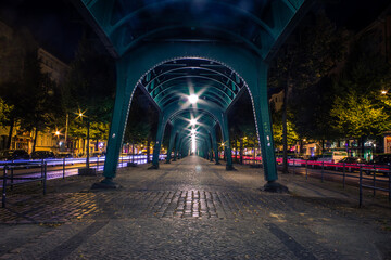 berlin schönhauser allee under bridge in city with long exposure traffic light trails urban city...