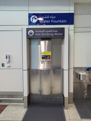 Self service hot and cold water drinking fountain at Dubai International Airport. Free water for long haul travellers to make refreshments or cleanse drinking vessels. 