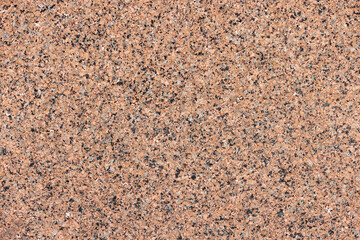 Texture and background of spotted granite wall in brown color.