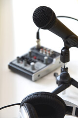 Podcast studio. Microphone headphones and equalizer. White black and yellow colored interior apartments for sound and talks produsing