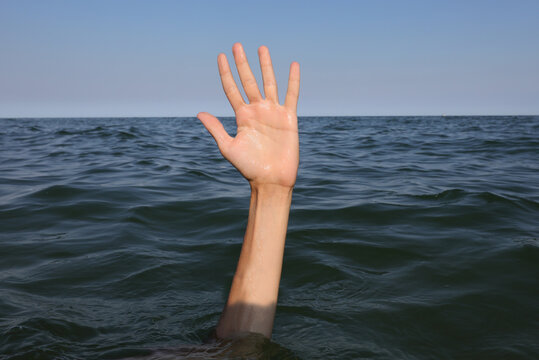 hand of the person who drowns in the sea
