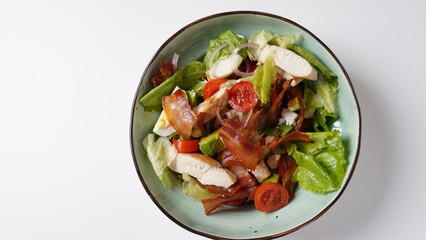 American cobb salad hard boiled eggs, cheese, avocado chunks, lettuce, grilled chicken breast, tomatoes and crispy fried bacon