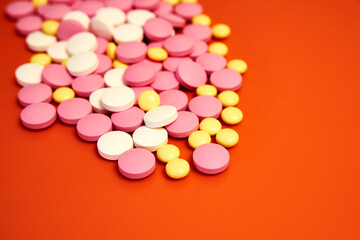 Scattered colorful pills. Multi-colored tablets without packaging