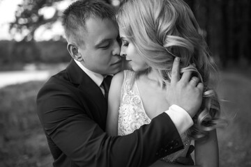 Happy wedding couple enjoy each other in the park. Wedding day. Marriage. The concept of youth, love, fashion and lifestyle.