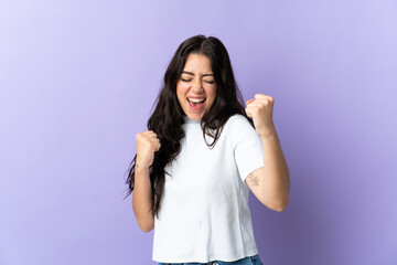 Young caucasian woman isolated on purple background celebrating a victory