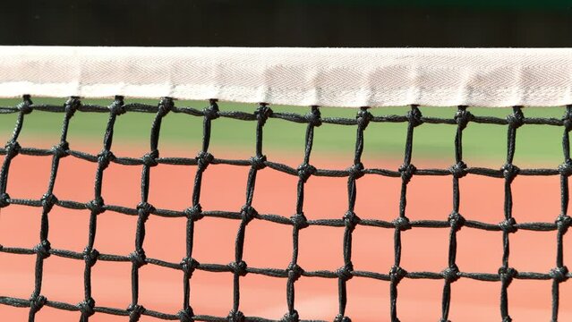 Super Slow Motion Shot of Tennis Ball Hitting the Net on Court at 1000fps.