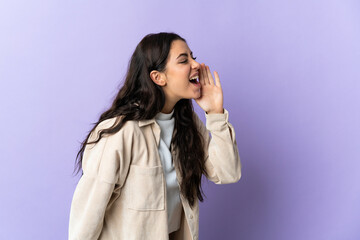 Fototapeta premium Young caucasian woman isolated on purple background shouting with mouth wide open to the side