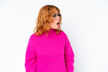 Young caucasian woman isolated on white background doing surprise gesture while looking to the side