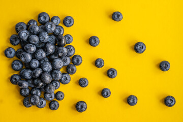 Close-up of blueberries on a bright yellow background 