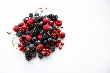 Berries are placed in a pile on a white background flatlay