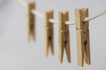 Den Helder, Netherlands. July 2022. Wooden clothes pegs on a white background. Selective focus.