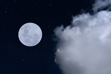 Full moon with clouds and stars in the dark night.