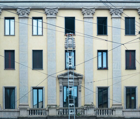 mobile platform used to move. metal staircase on the facade of a period building.Milan - Italy