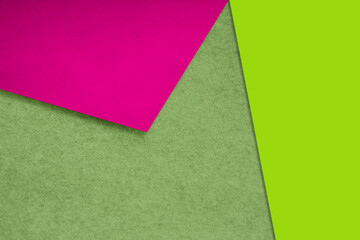 Plain and Textured purple pink green papers randomly laying to form M like pattern and triangle for creative cover design idea