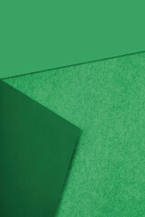 Green asphalt abstract background with lines forming triangle like shapes and blank space for creative design cover