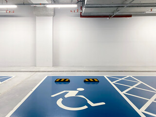 Disabled symbol sign for handicapped on blue colour parking space.  Parking space for handicapped people