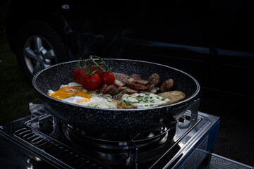cooking dinner on the stove while camping.