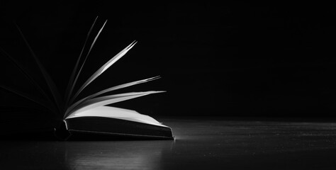 Open book close up,backlighting black and white, reading, education, knowledge,home office concept.