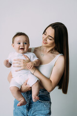 Happy young mother with her son over white background