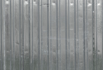 The texture of the fence made of green profiled sheet. Background. Space for text.